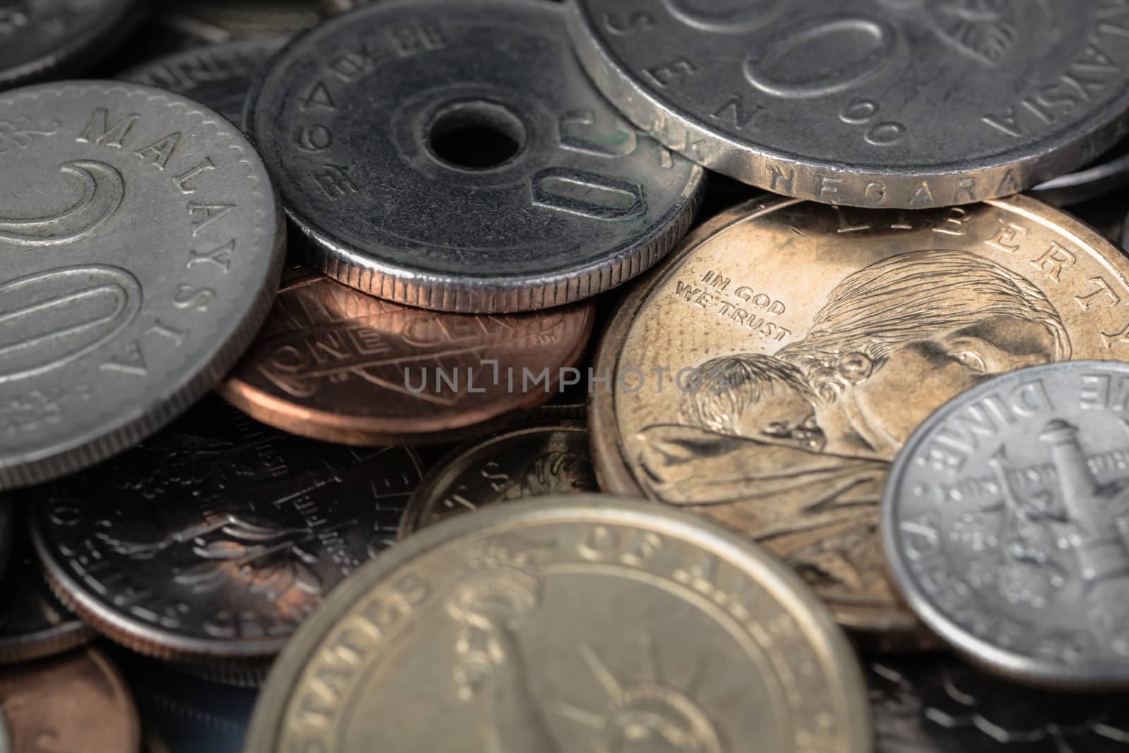 US American coin with wording "in God we trust" and many international currency