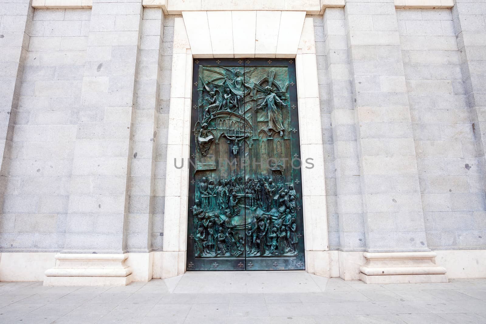 Madrid, Spain - May 6, 2012: Sculpted entrance gate of Almudena cathedral by artist Consuelo Perea, facade de Balien on a spring day in Madrid, Spain