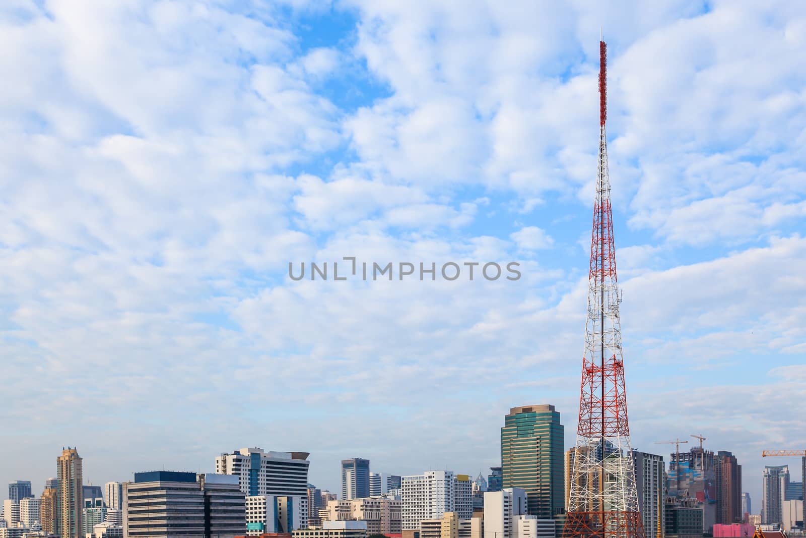 many clouds cover the cityscape business building with antenna t by FrameAngel