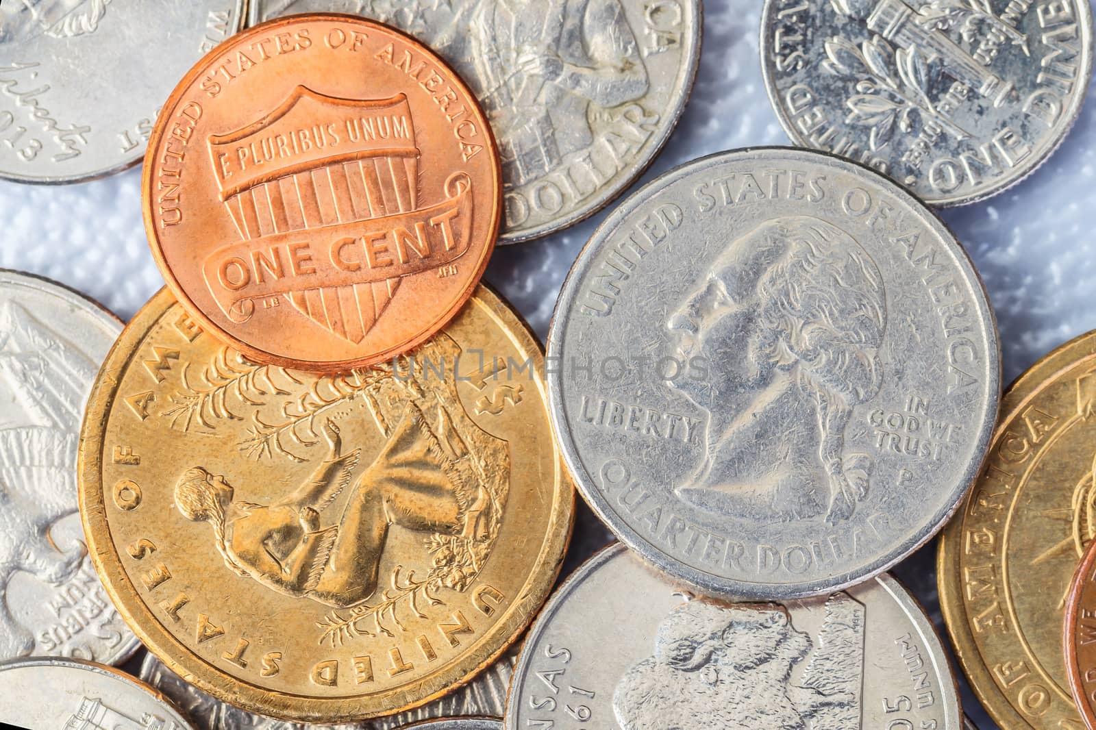 Group of US American coins and one cent on top