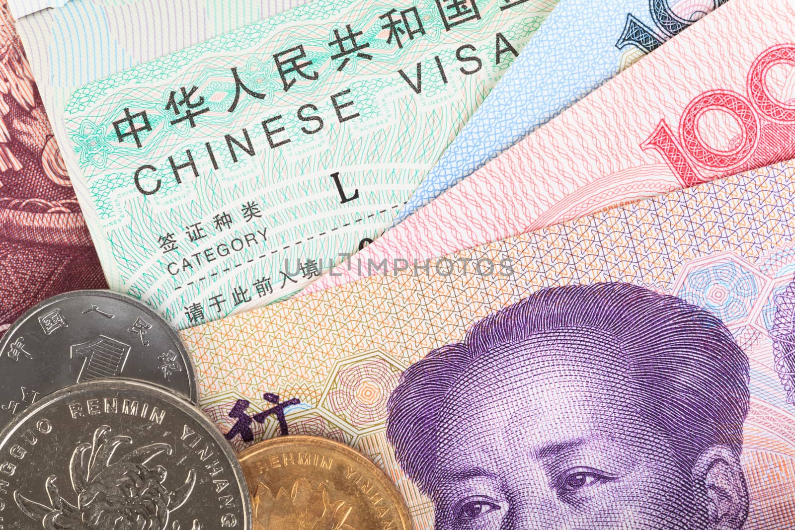 Chinese or Yuan banknotes money and coins from China's currency with visa for travel concept, close up view as background