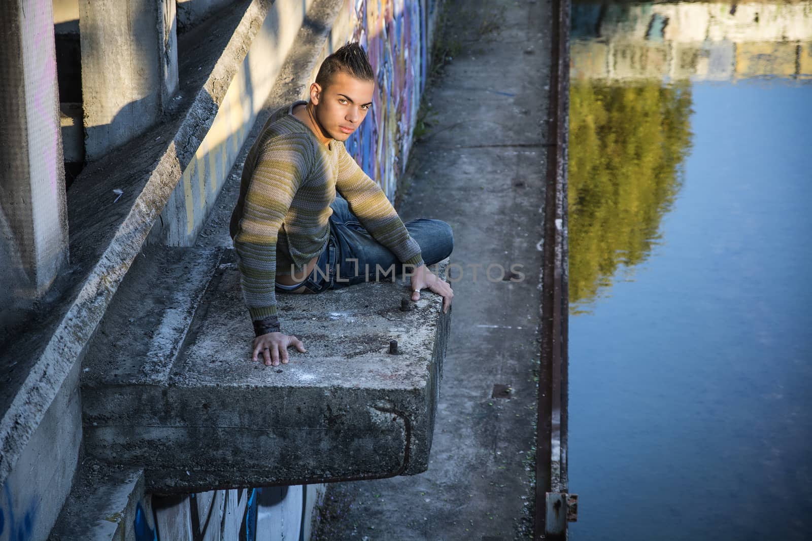 Handsome young man on concrete structure by artofphoto