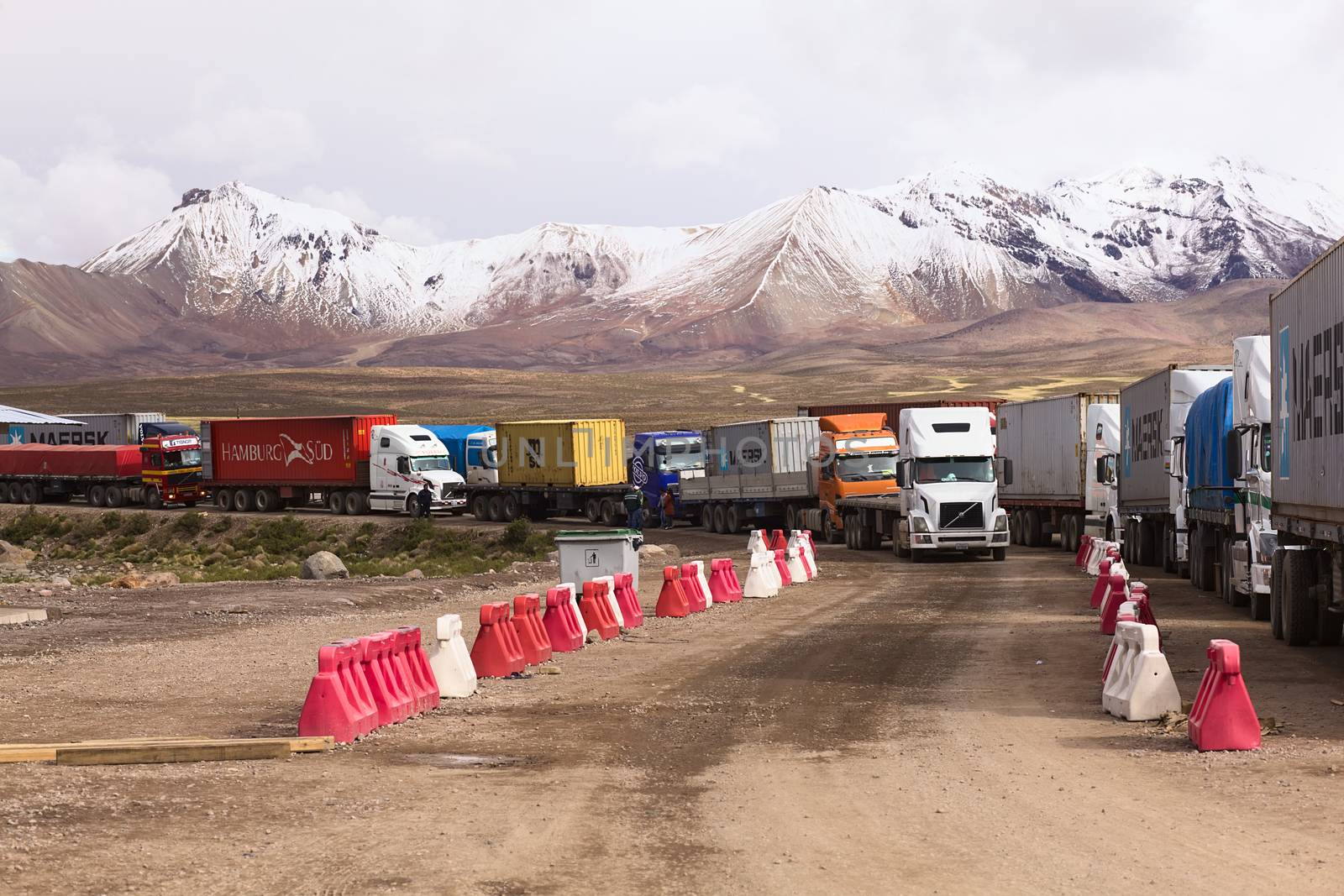 PASO CHUNGARA-TAMBO QUEMADO, CHILE-BOLIVIA - JANUARY 21, 2015: Trucks standing in line at the border crossing between Chile and Bolivia at Chungara and Tambo Quemado on the way between La Paz and Arica on January 21, 2015