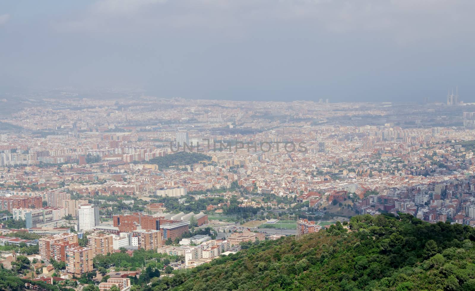 Panorama on Barcelona city at hot summer day from Montjuic castle, Catalonia, Spain