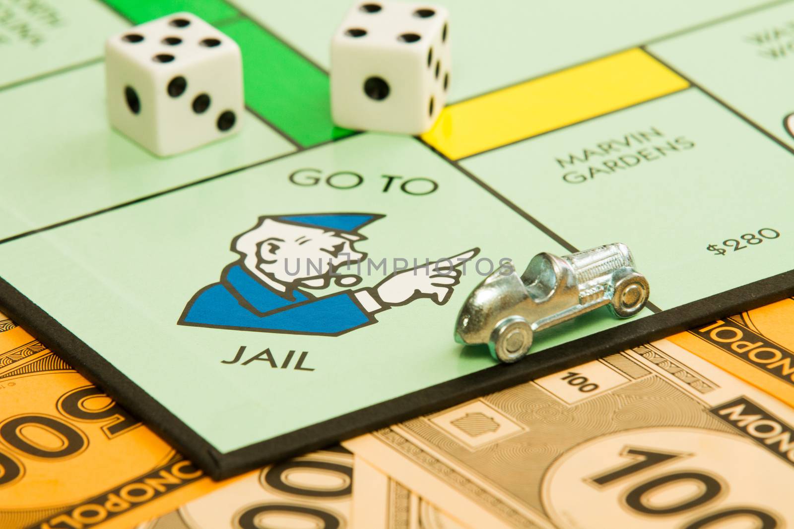 BOISE, IDAHO - NOVEMBER 18, 2012:  The car piece is speeding away from the go to jail spot on the famous Hasbro game Monopoly.