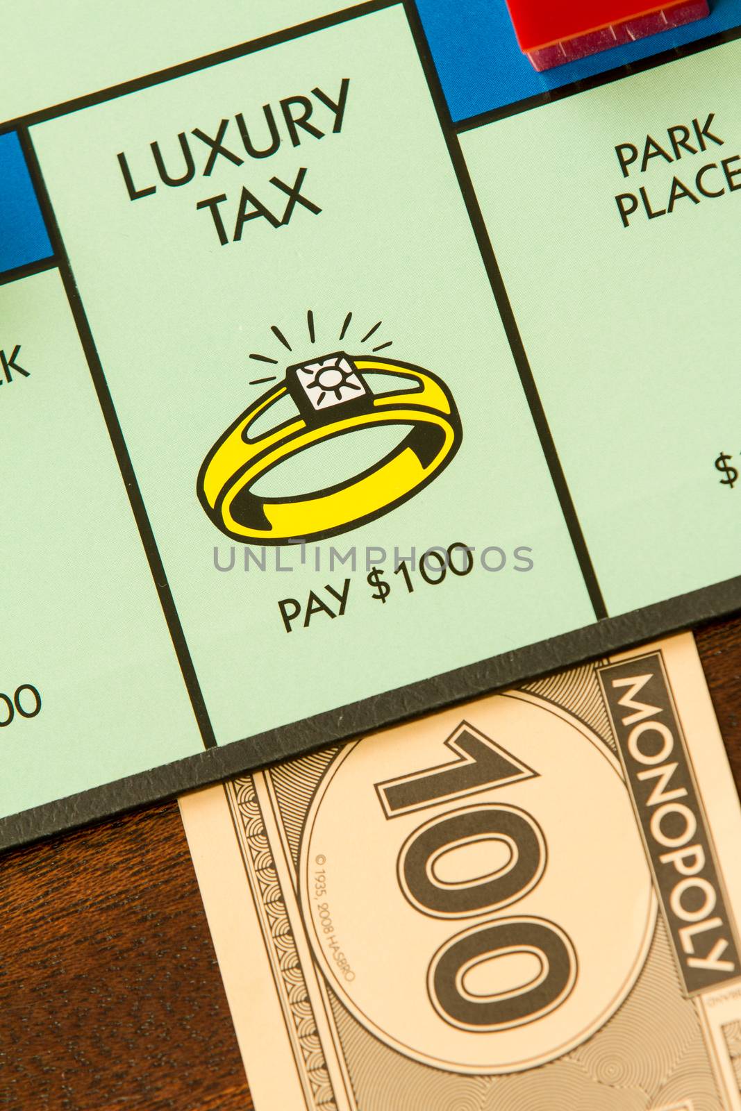 BOISE, IDAHO - NOVEMBER 18, 2012: The imposted luxury tax for landing on the wrong spot of the Hasboro game Monopoly