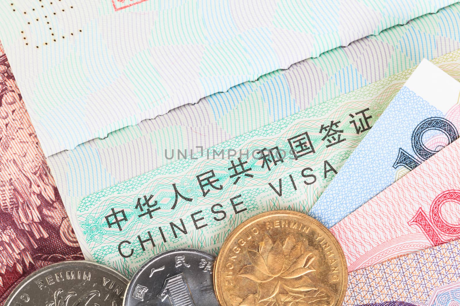 Chinese or Yuan banknotes money and coins from China's currency with visa for travel concept, close up view as background