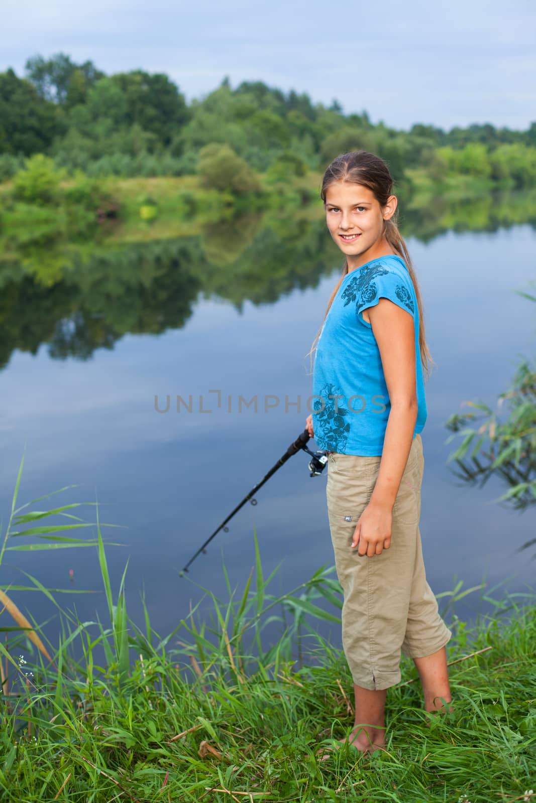 Summer vacation - Photo of cute girl fishing on the river.