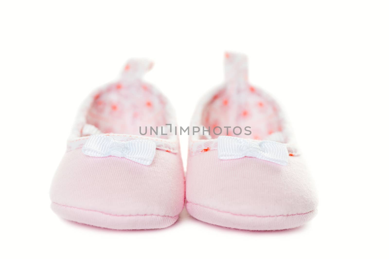 Pink baby sneakers closeup isolated by Nanisimova