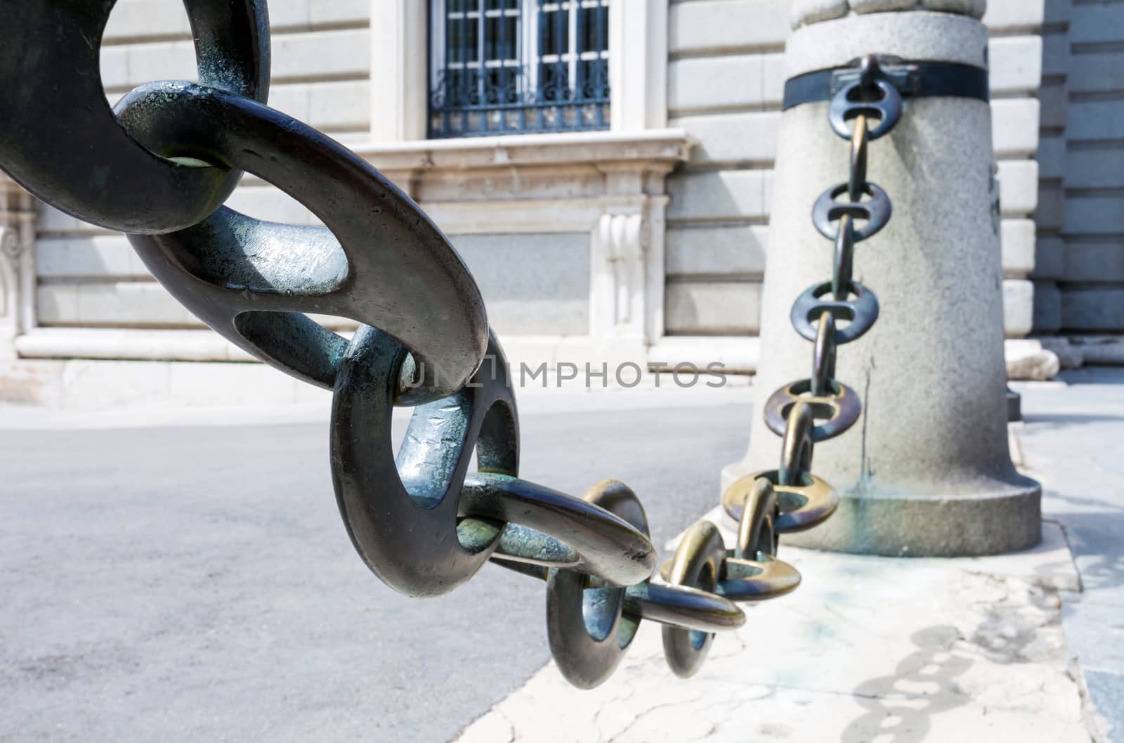 Massive metal chain on sidewalk in Madrid, Spain