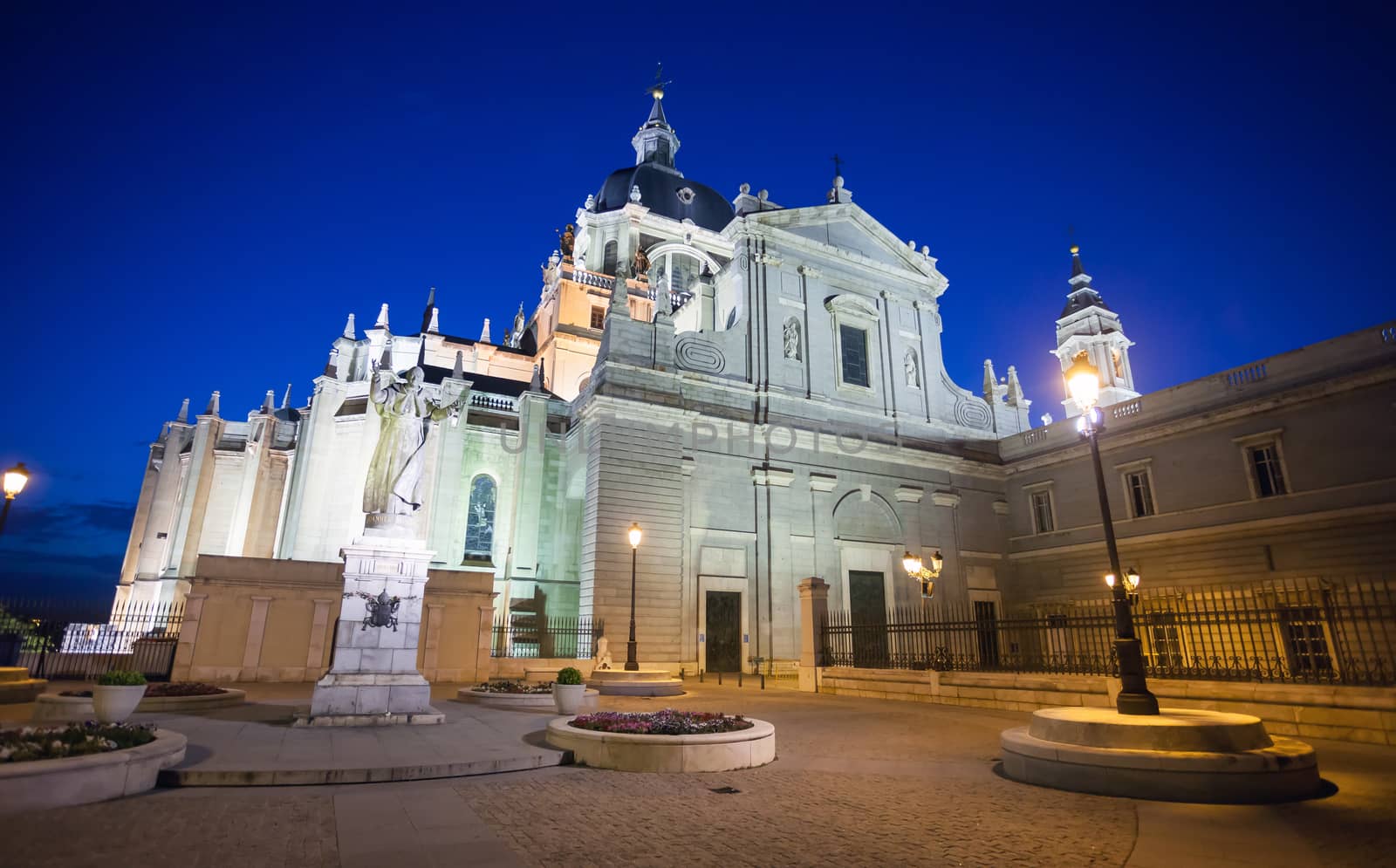 Madrid, Spain - May 10, 2012: Pope John Paul II statue in front of Cathedral Almudena on a spring night in Madrid, Spain