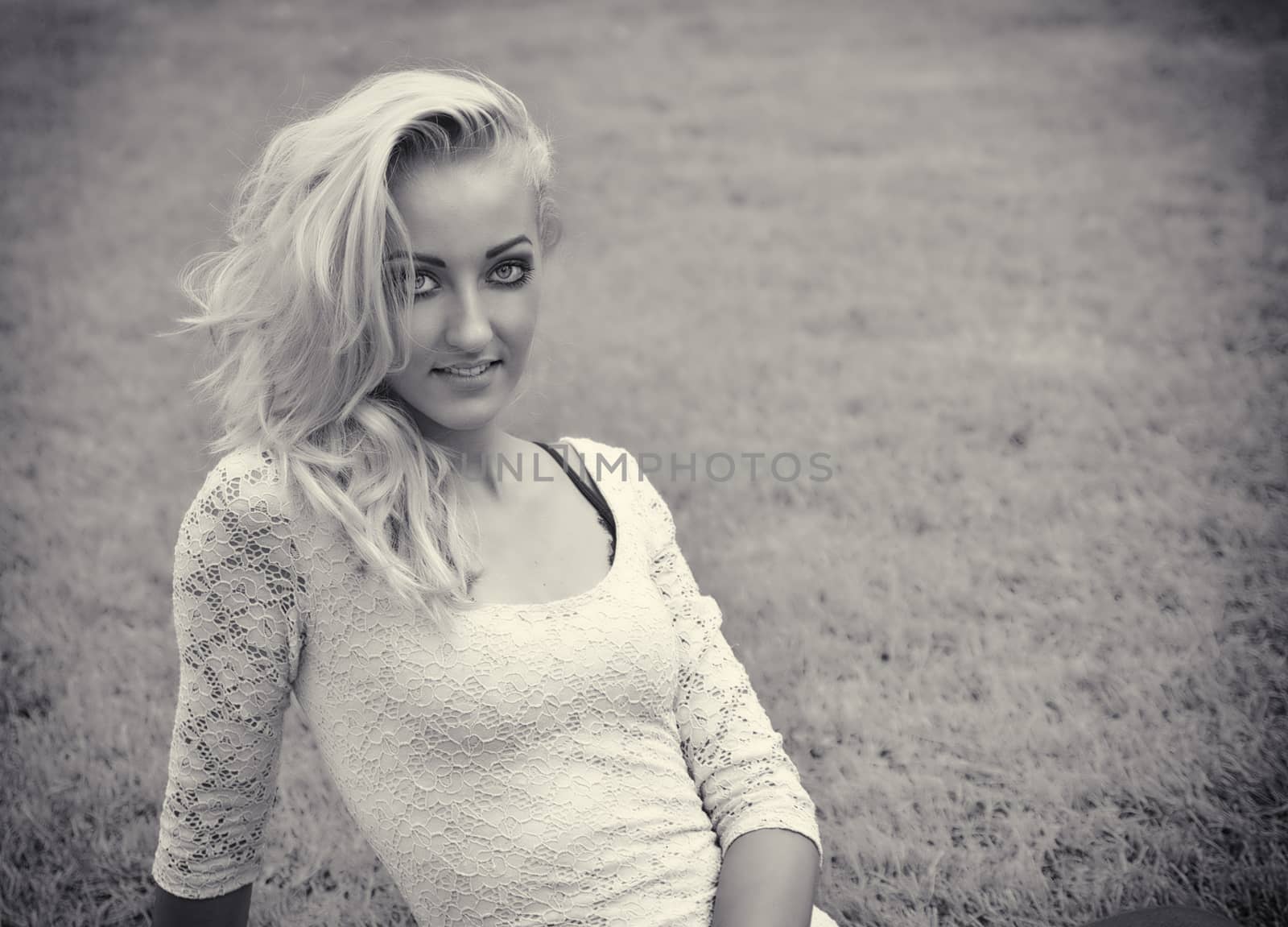 Pretty blonde young woman outdoor laying down on grass by artofphoto