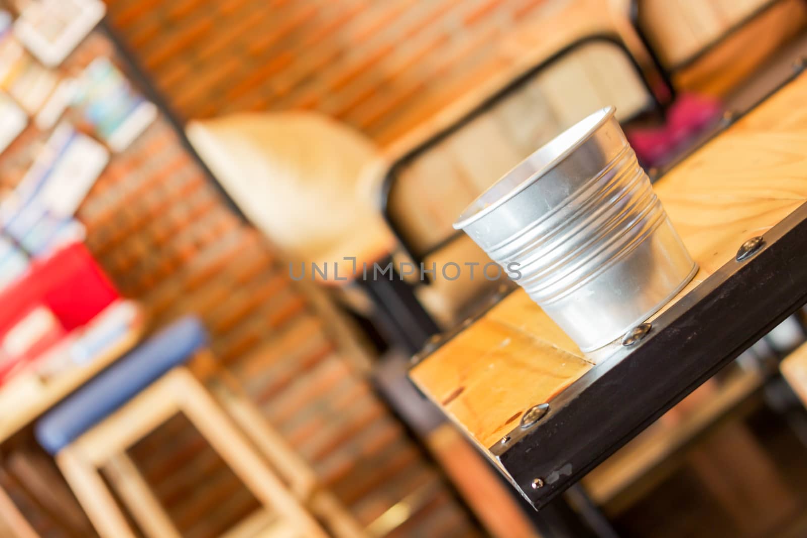 Empty bucket on the table in coffee shop, stock photo