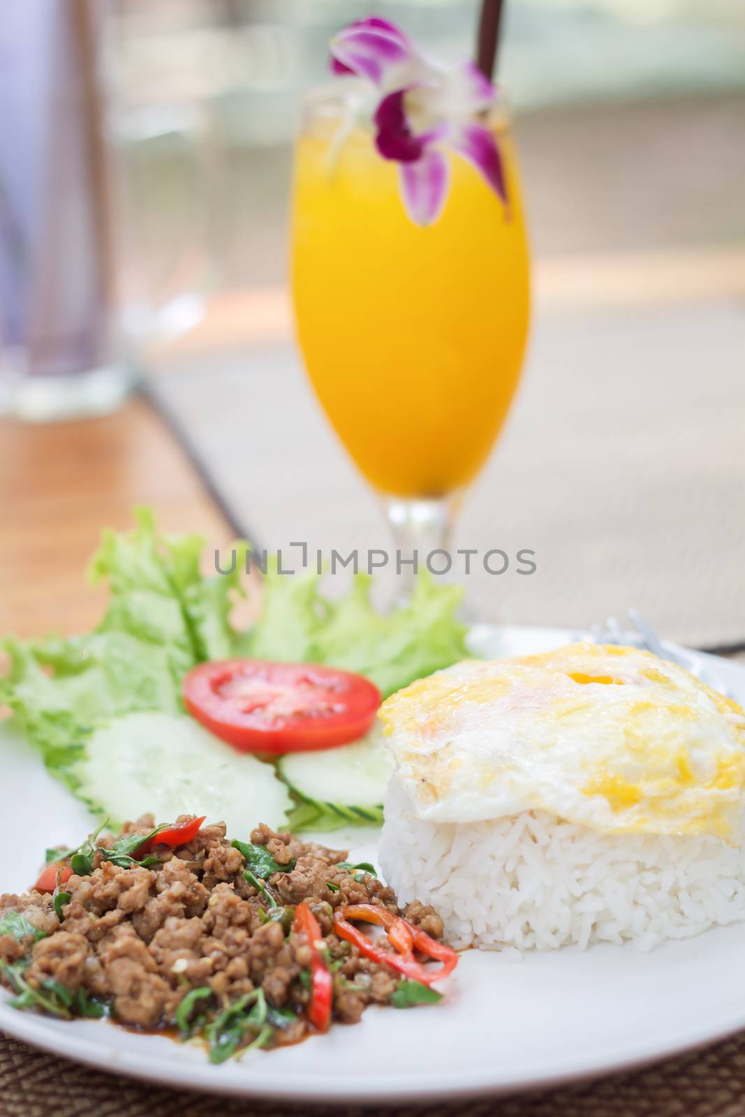 Thai spicy food basil pork fried rice with fried egg, stock photo