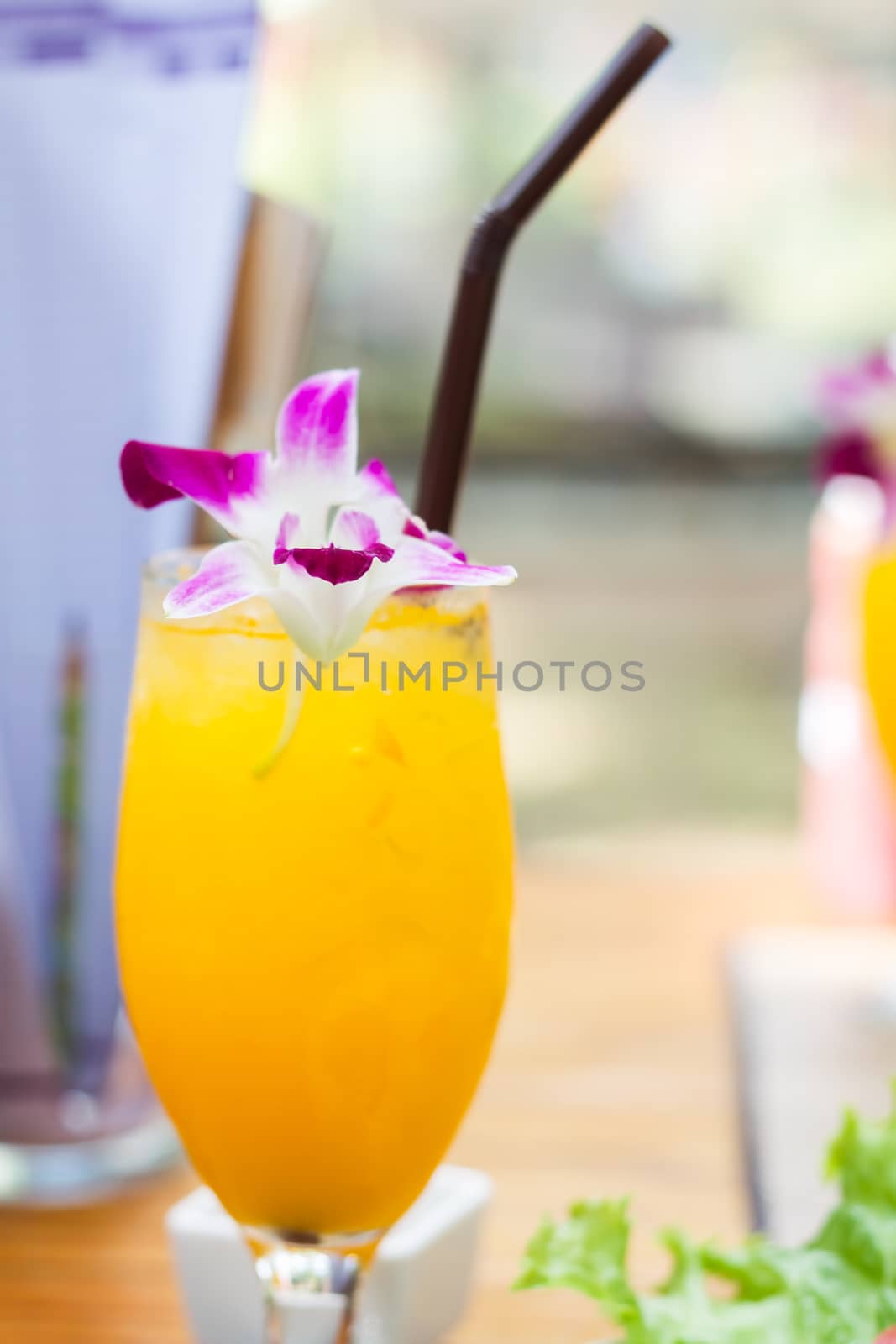 Glass of iced orange juice by punsayaporn