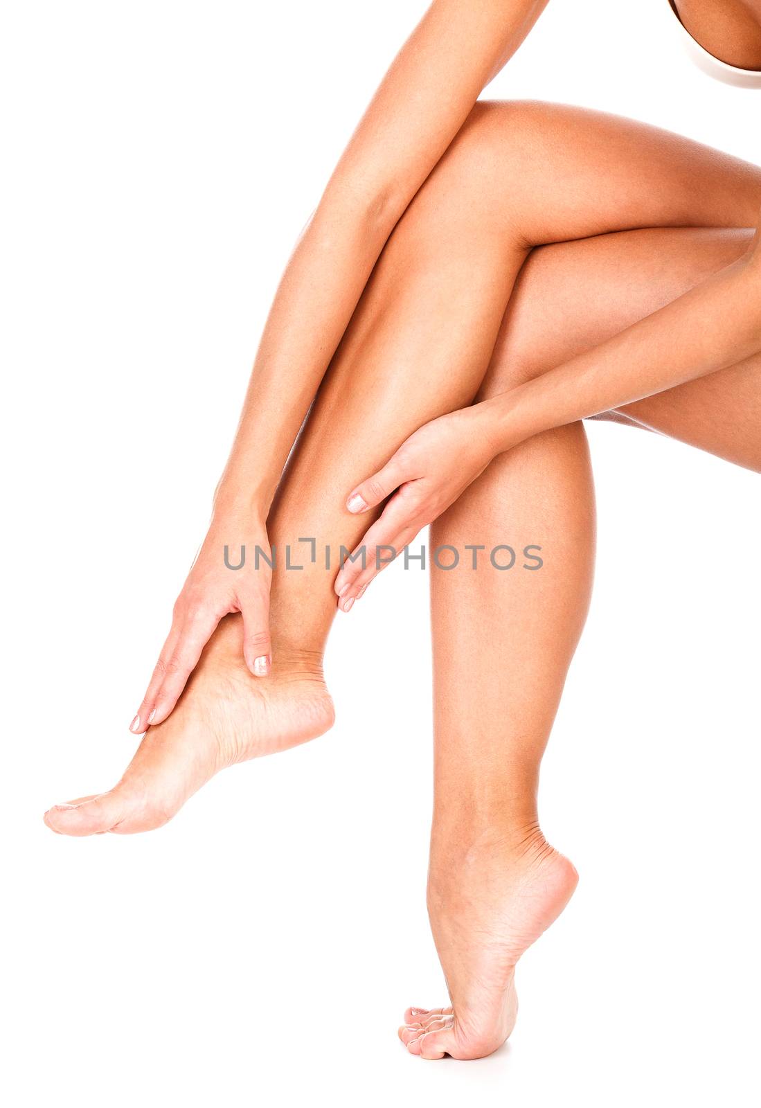 Female legs and hands, white background, copyspace, isolated
