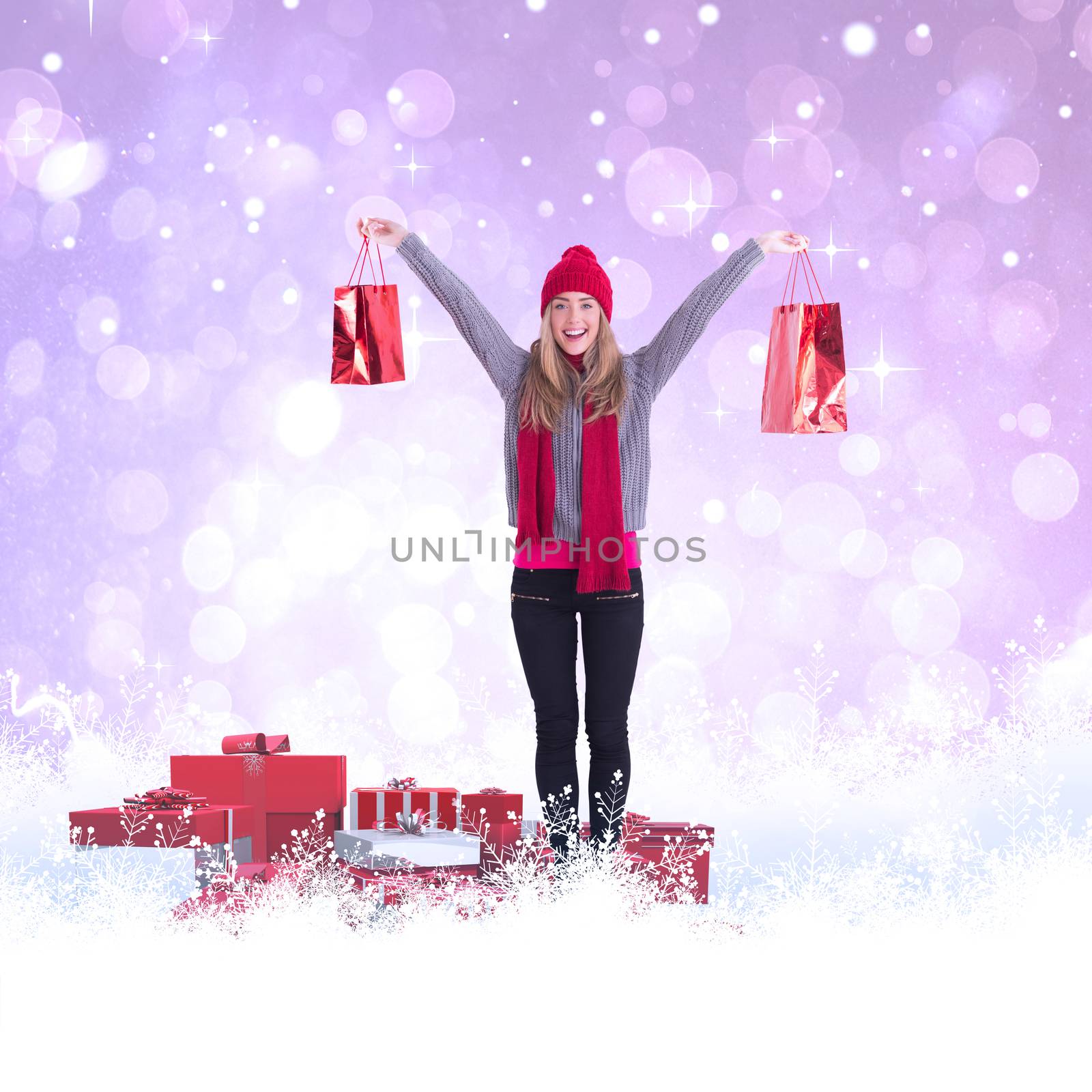Composite image of festive blonde holding shopping bags by Wavebreakmedia