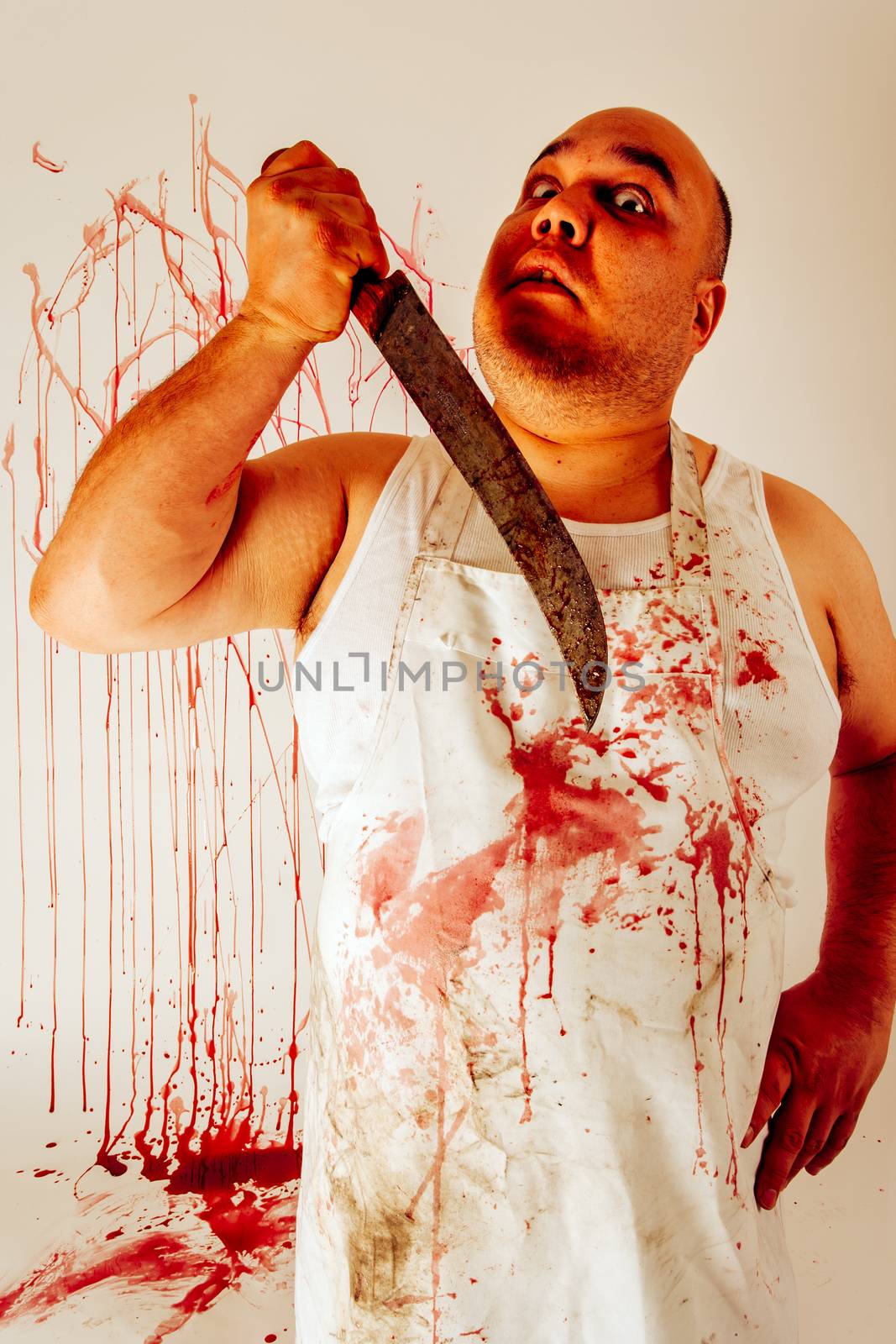 Crazy insane butcher covered with blood.  Harsh lighting for more disturbing feel.
