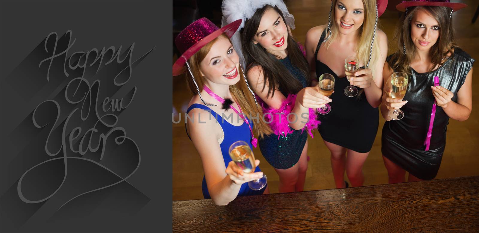 Happy gorgeous women holding flutes of champagne having hen party against classy new year greeting