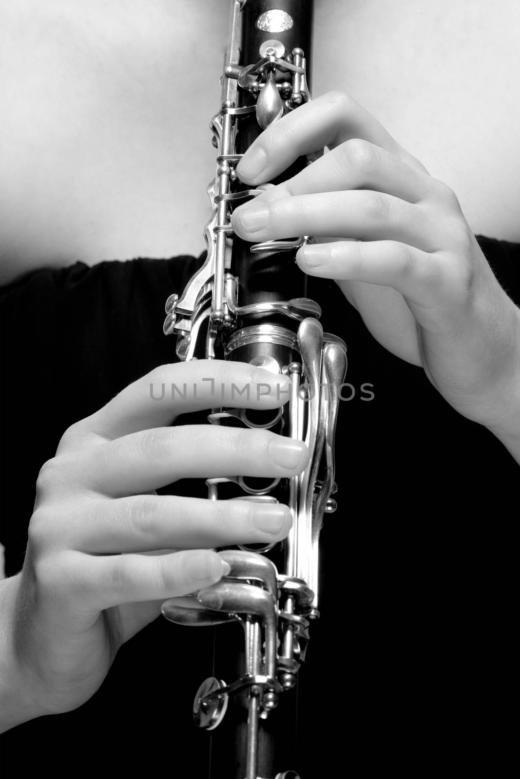 Hands of Female Musician Playing Clarinet by courtyardpix