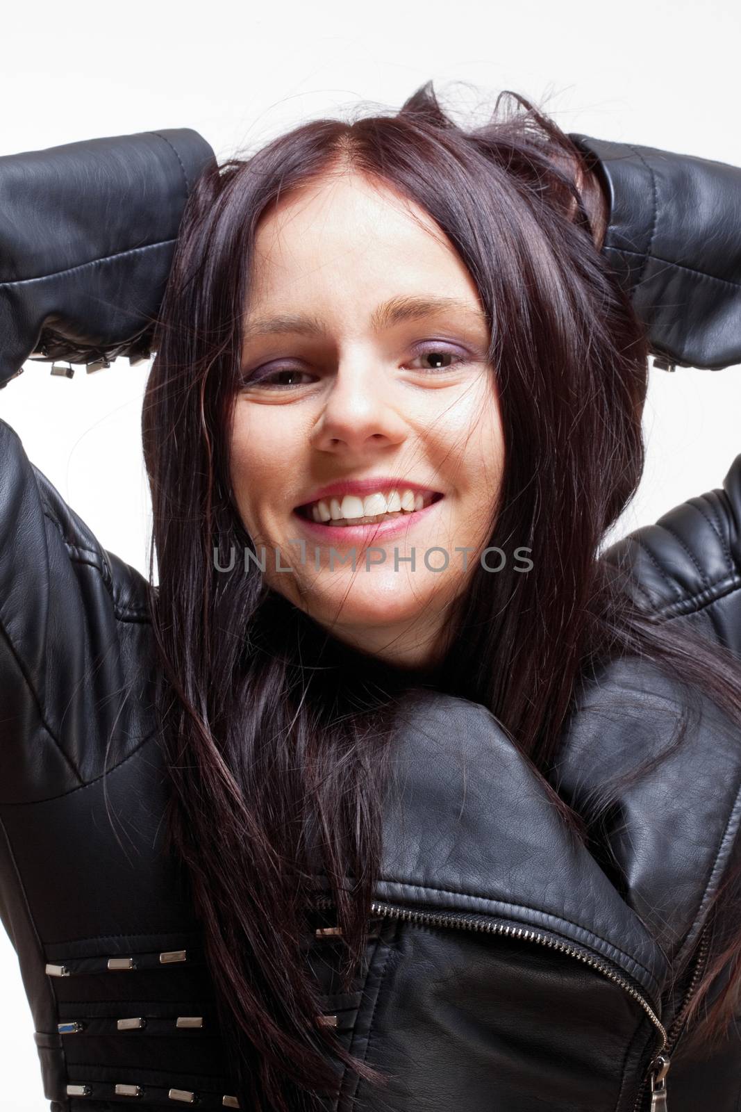 Portrait of a Young Woman in Leather Jacket Smiling - Isolated on Gray