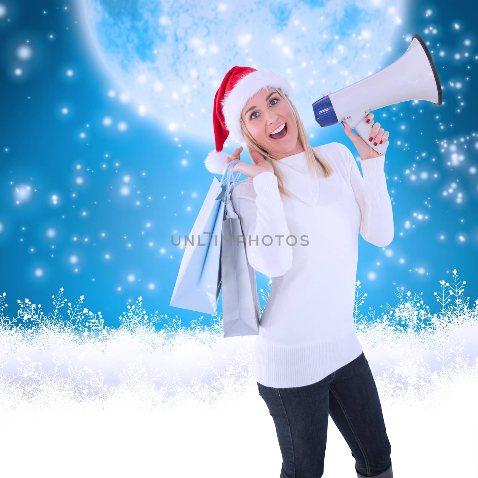 Festive blonde holding gift bags and megaphone against blue background with vignette