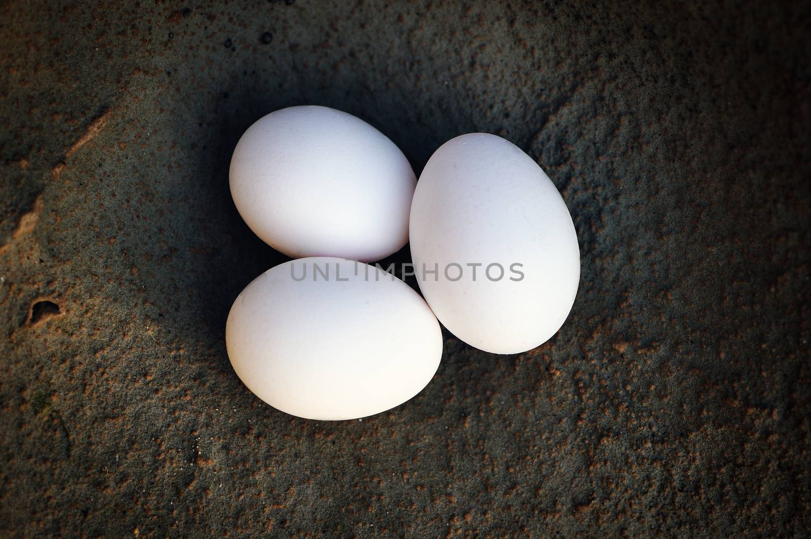 Hen's eggs on the stone surface