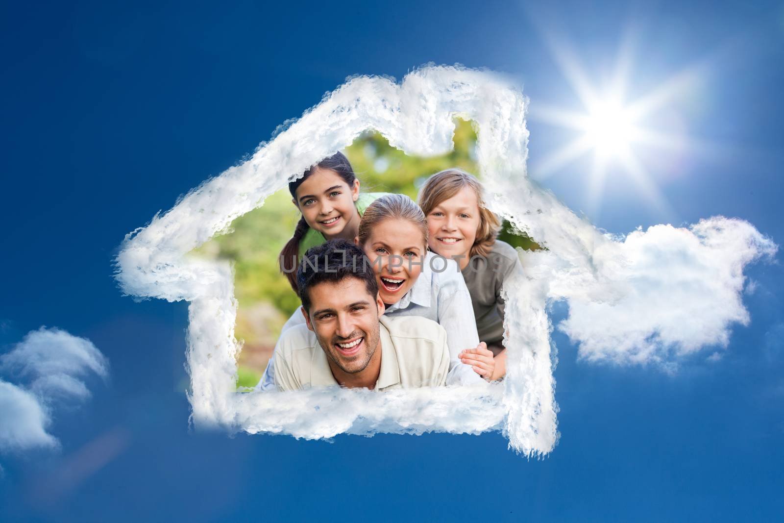 Happy family in the park against bright blue sky with clouds