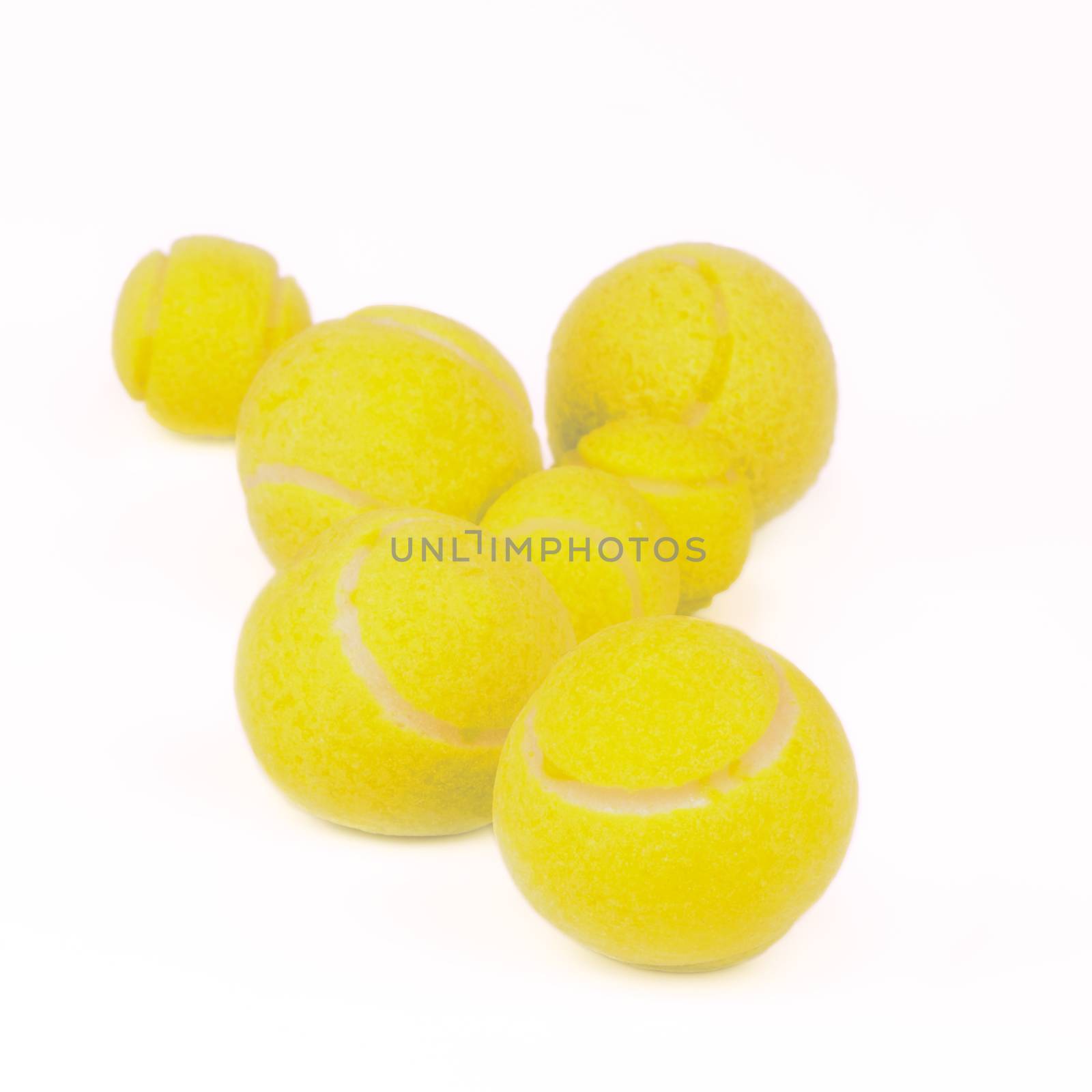 Arrangement of Tennis Balls isolated on white background. Focus on Foreground