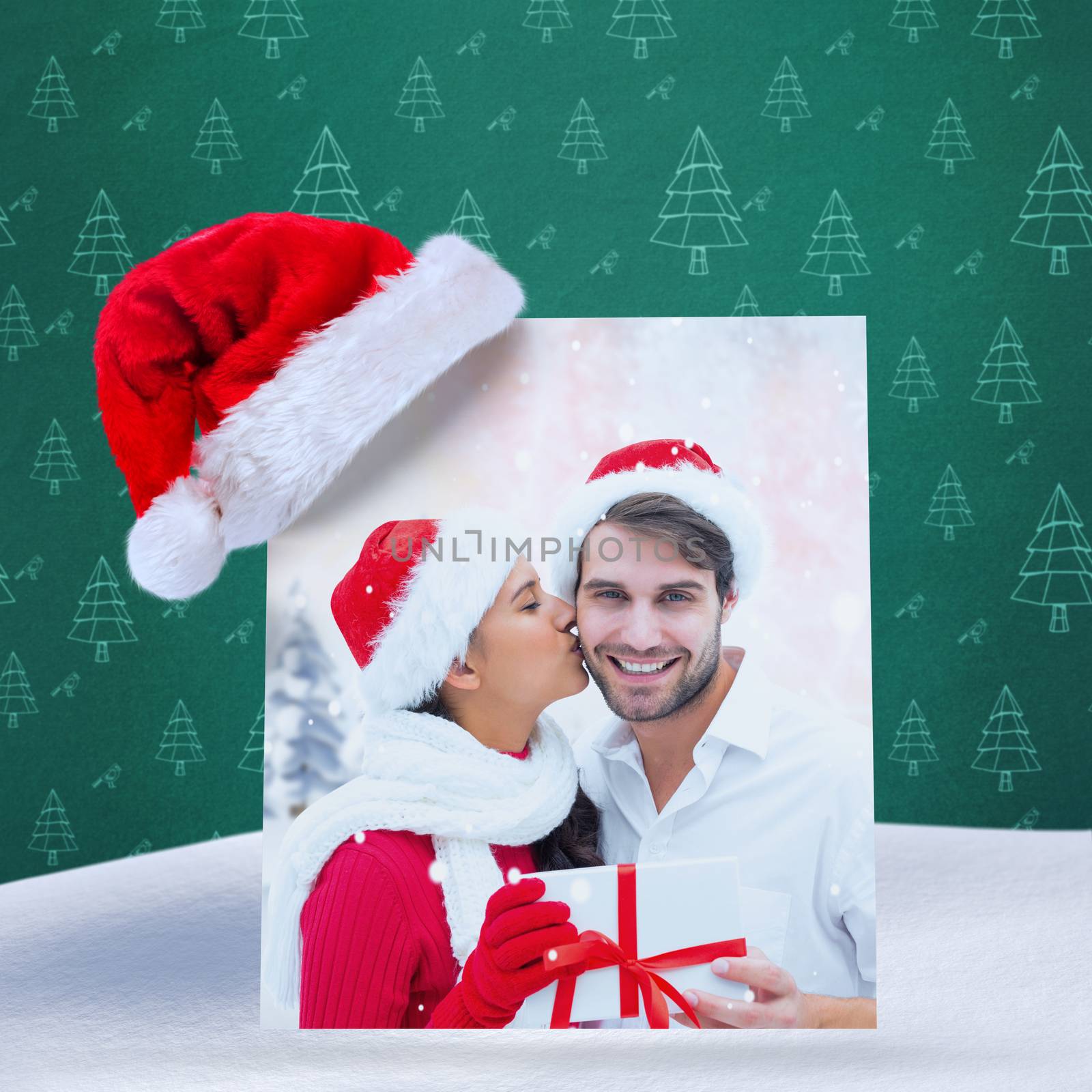 Composite image of festive young couple holding gift by Wavebreakmedia