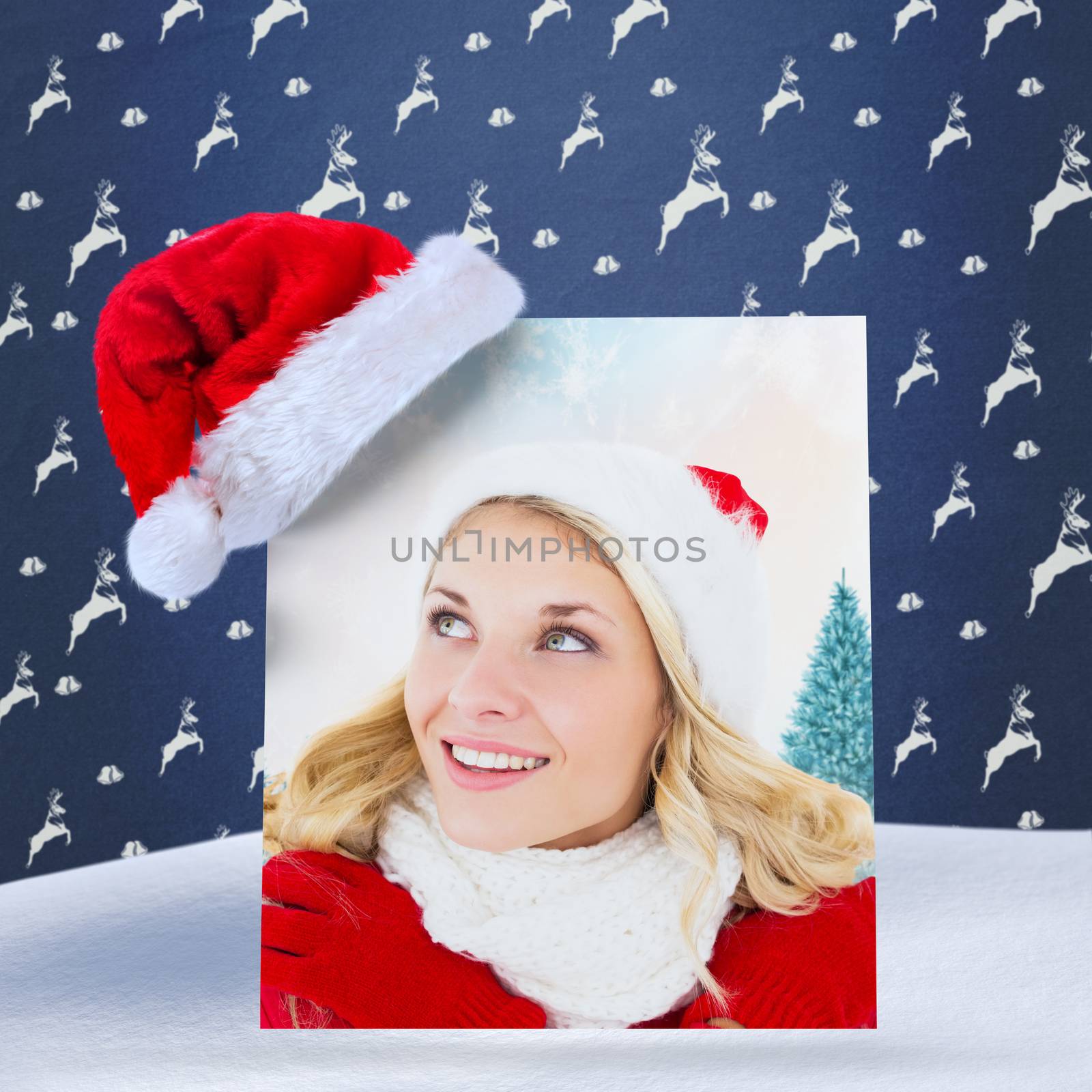 happy festive blonde  against blue reindeer pattern