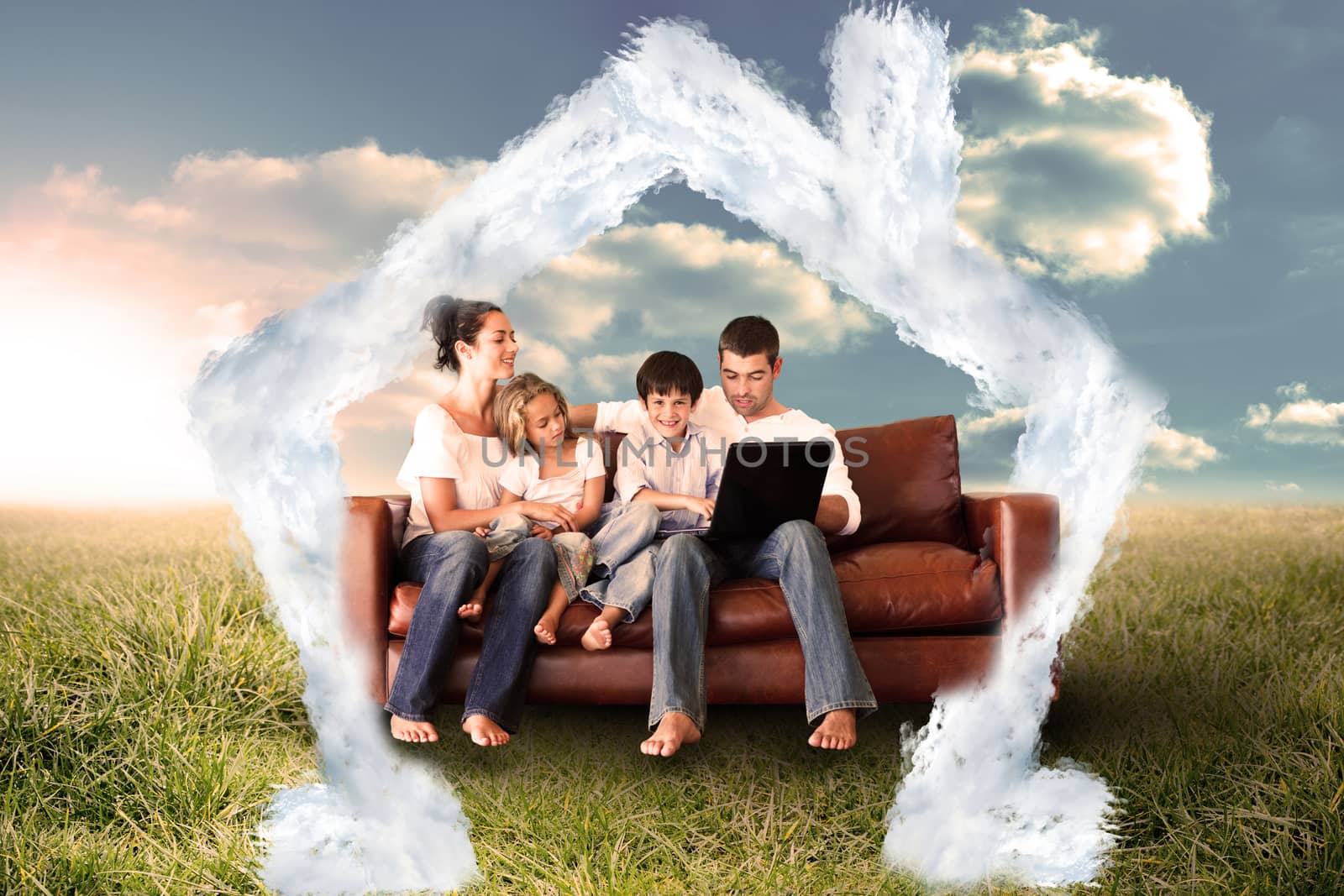 Composite image of happy family using the laptop in a field by Wavebreakmedia