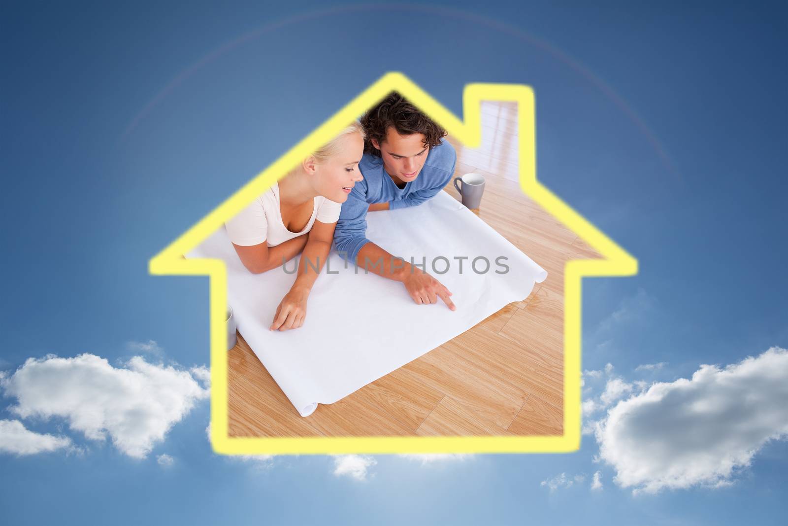 Cute man showing a point on a plan to his fiance against cloudy sky with sunshine