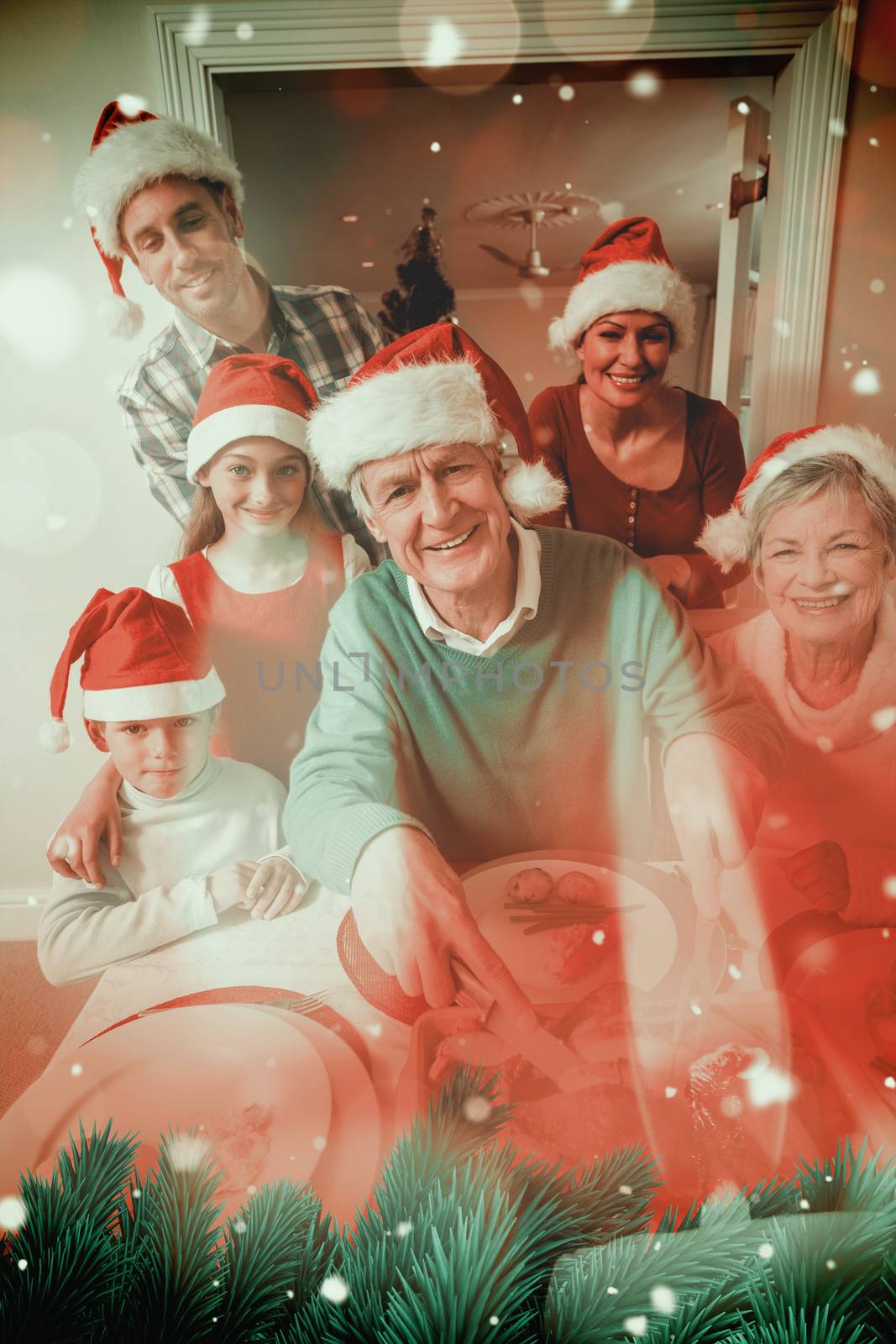 Grandfather in santa hat carving chicken at christmas dinner against candle burning against festive background