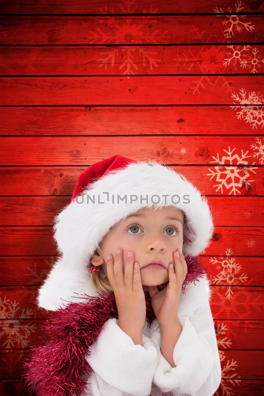 Cute little girl wearing santa hat and tinsel against snowflake pattern on red planks