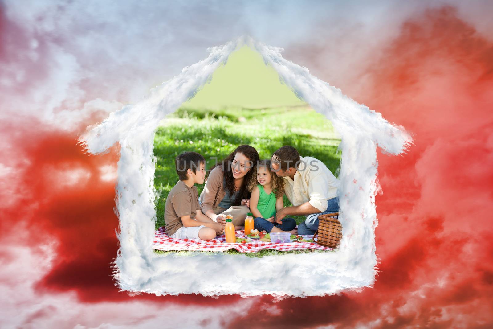 Family picnicking together against green grass under red cloudy sky