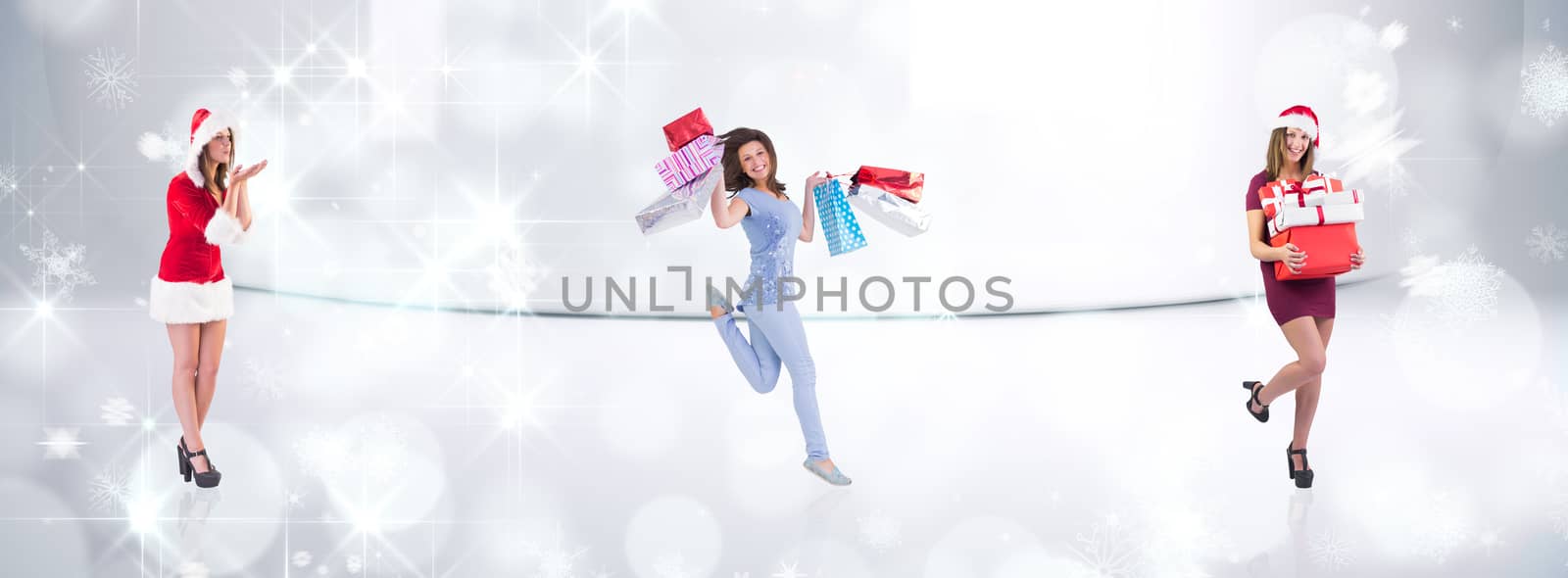 Festive brunette holding pile of gifts against snowflakes in room