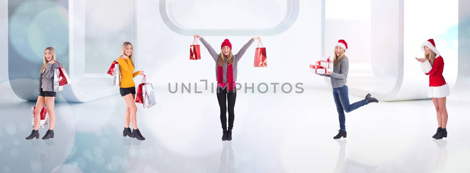 Stylish blonde holding shopping bags against lights twinkling in modern room