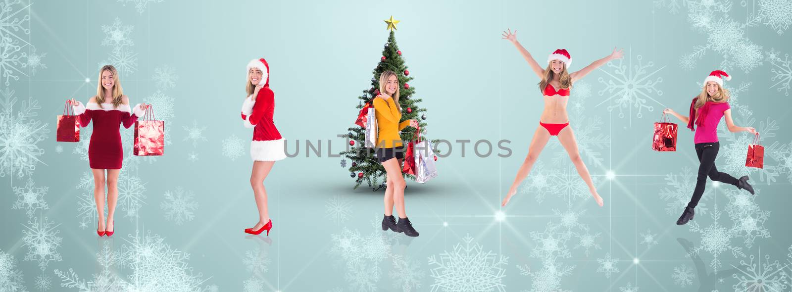 Composite image of festive blonde carrying gift bags by Wavebreakmedia