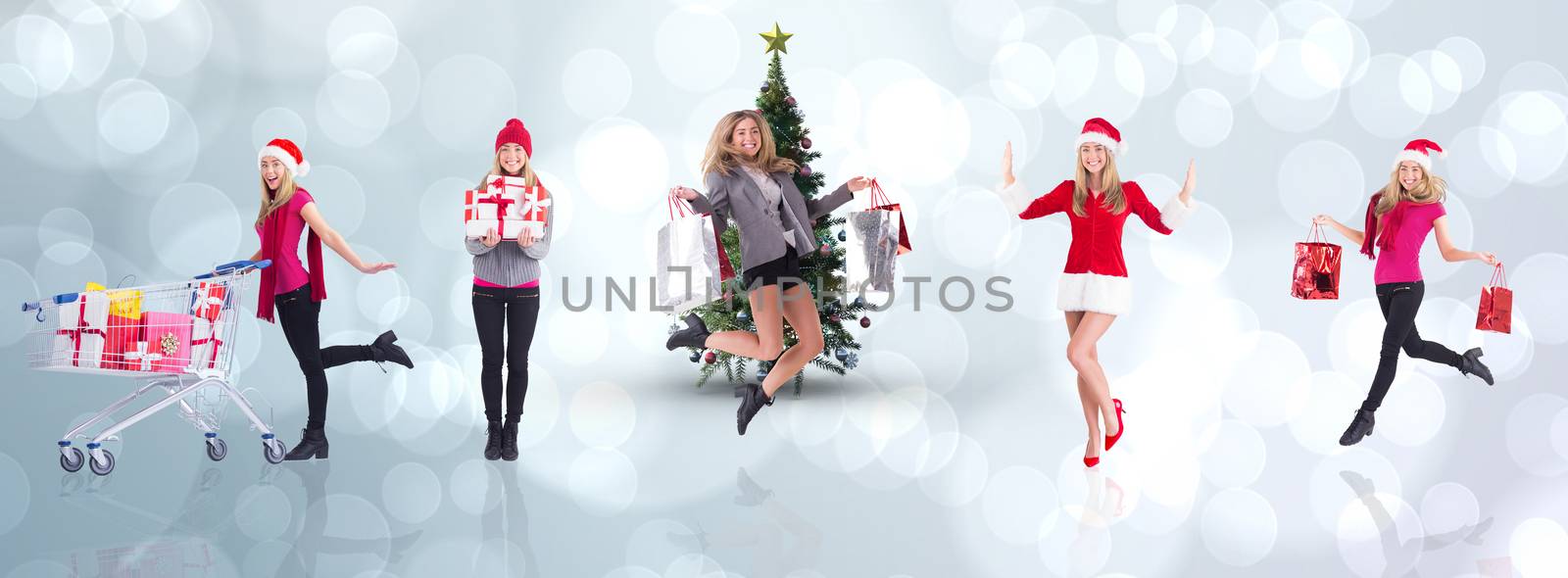 Composite image of festive blonde carrying gift bags by Wavebreakmedia