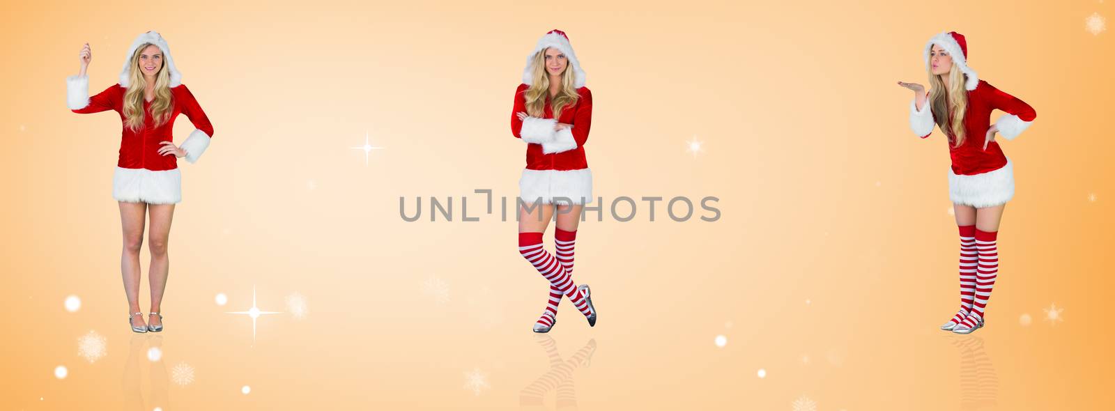 Composite image of pretty girl in santa outfit holding hand up by Wavebreakmedia