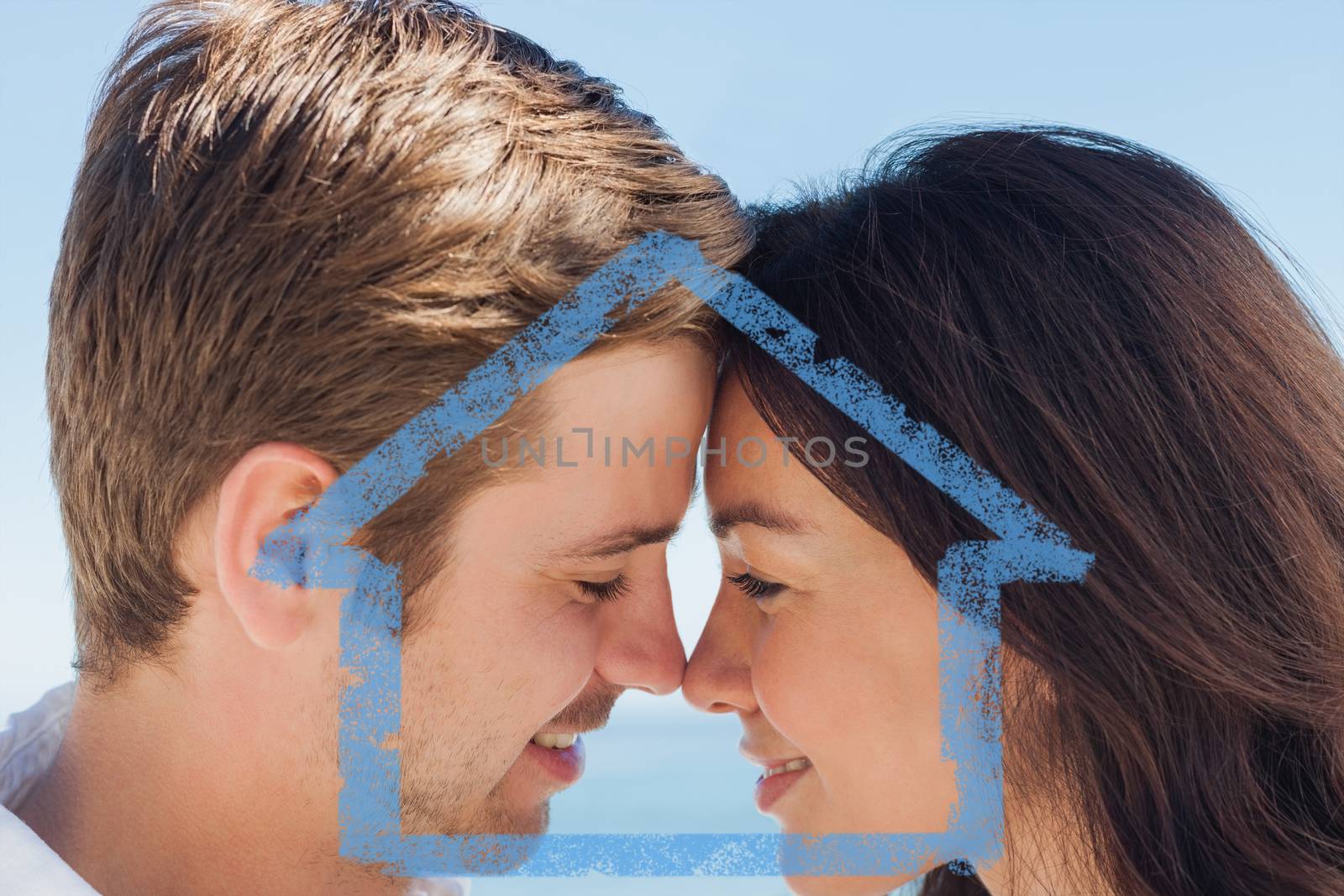 Close up view of romantic couple against house outline