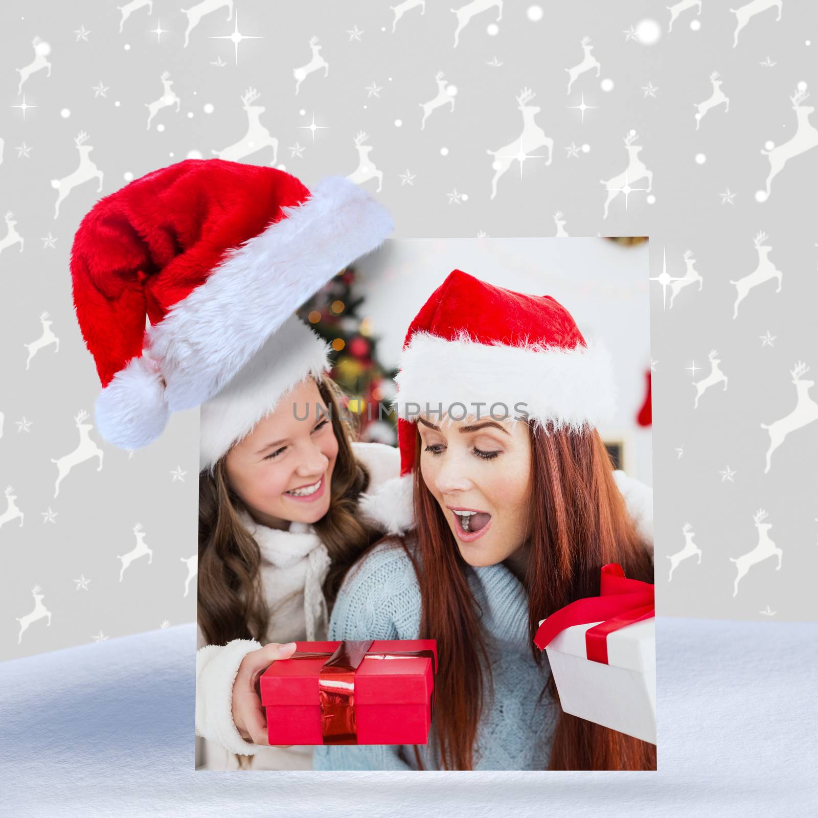 Composite image of festive mother and daughter exchanging gifts by Wavebreakmedia