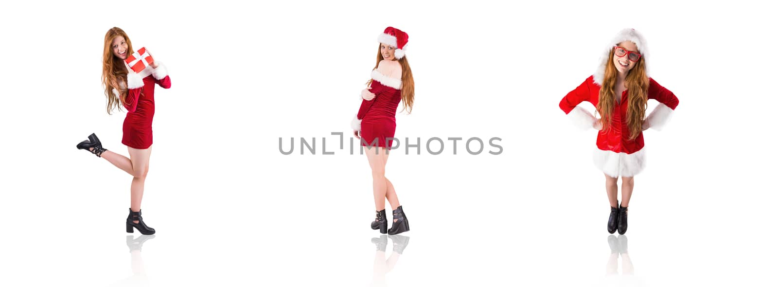 Composite image of festive redhead holding a gift by Wavebreakmedia