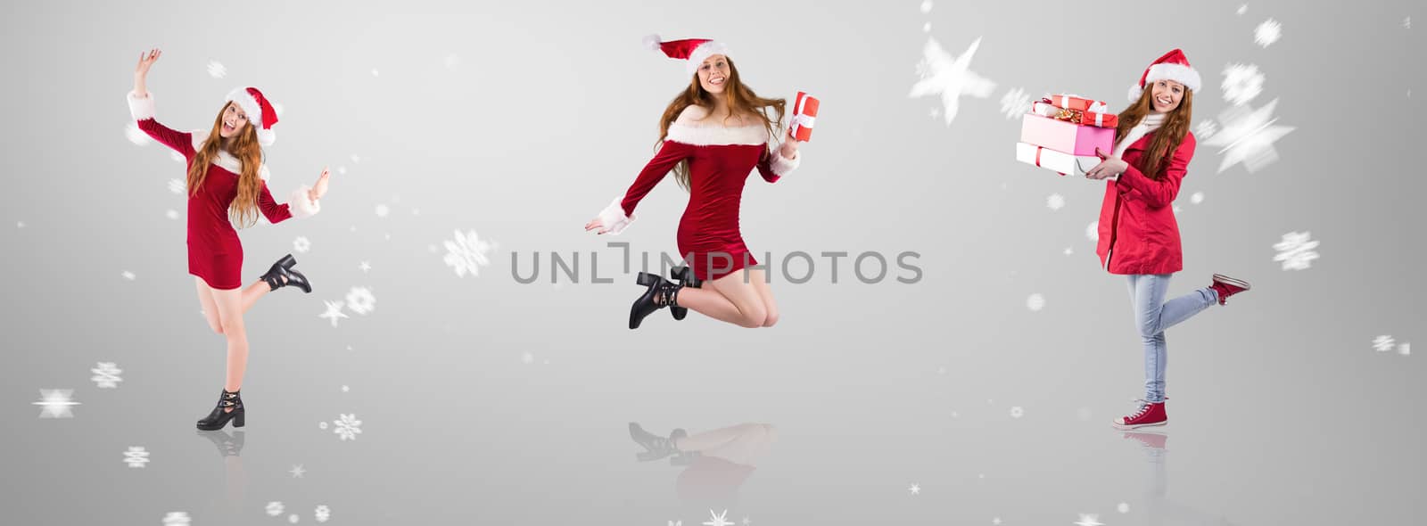 Festive redhead smiling at camera against grey vignette