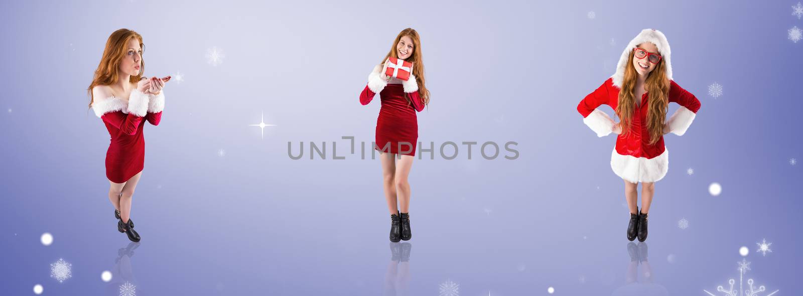 Festive redhead blowing over hands against purple vignette