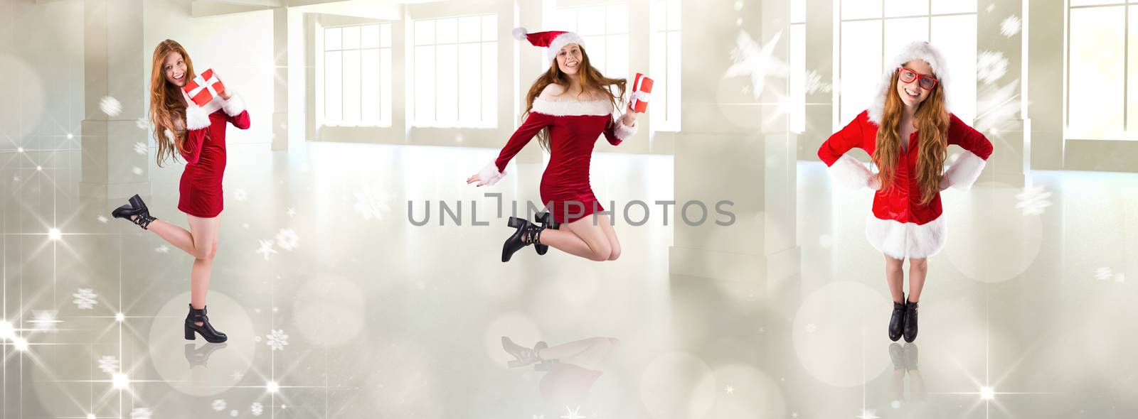 Festive redhead holding a gift against lights twinkling in modern room