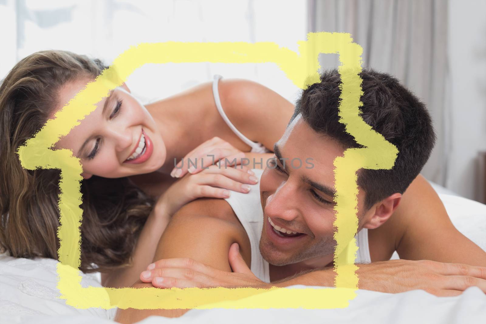 Romantic young couple in bed at home against house outline