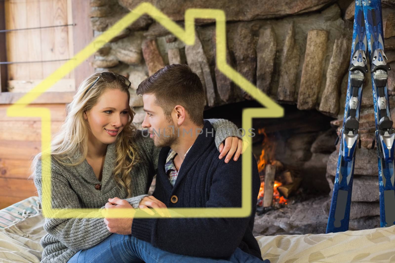 Romantic couple in front of lit fireplace against house outline