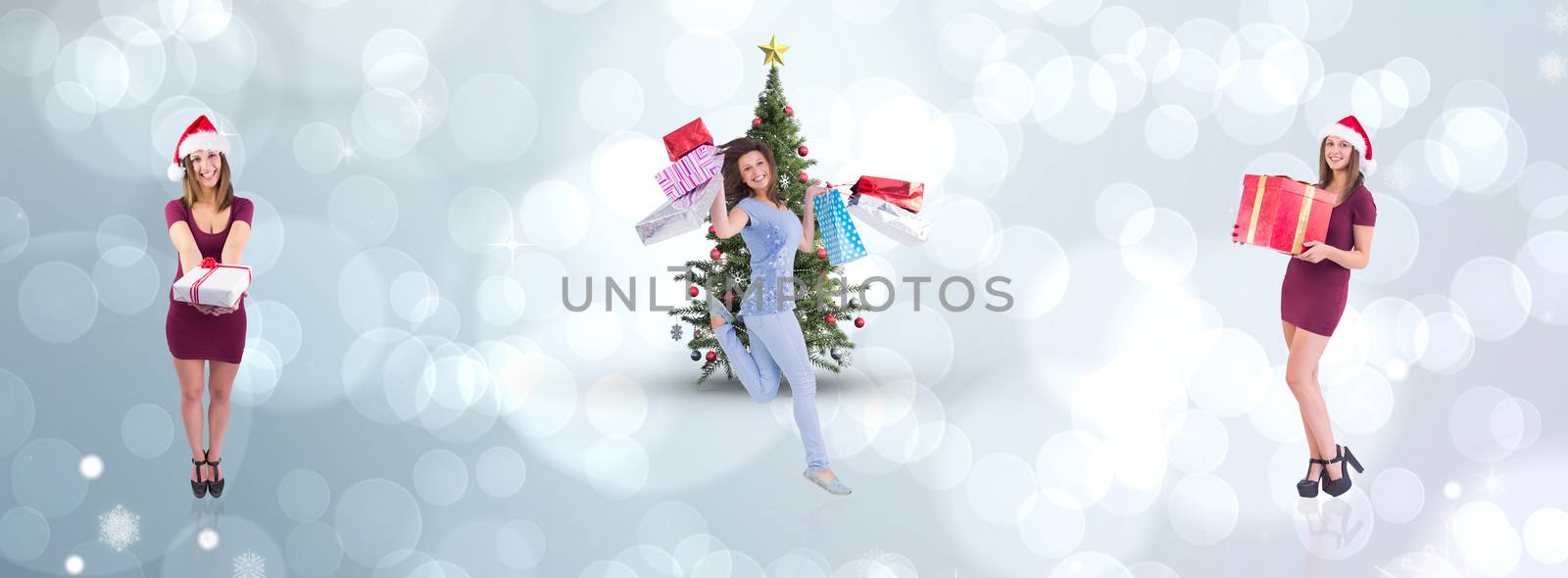 Festive brunette holding christmas gift against light glowing dots design pattern